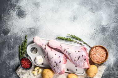 Beyaz kesim tahtasında baharatlı hindi budu. Gri arka plan. Üst Manzara. Metin için boşluk