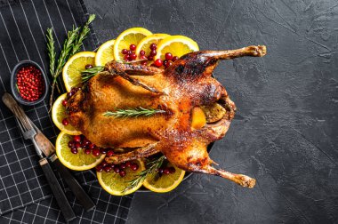 Portakal ve Rosmarina ile doldurulmuş fırında kaz. Kutlama masası. Siyah arka plan. Üst Manzara. Metin için boşluk