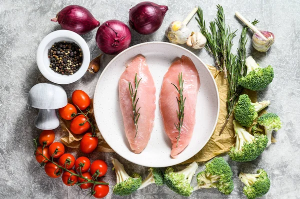 Turkey fillet. Farm poultry breast meat. Gray background. Top view.