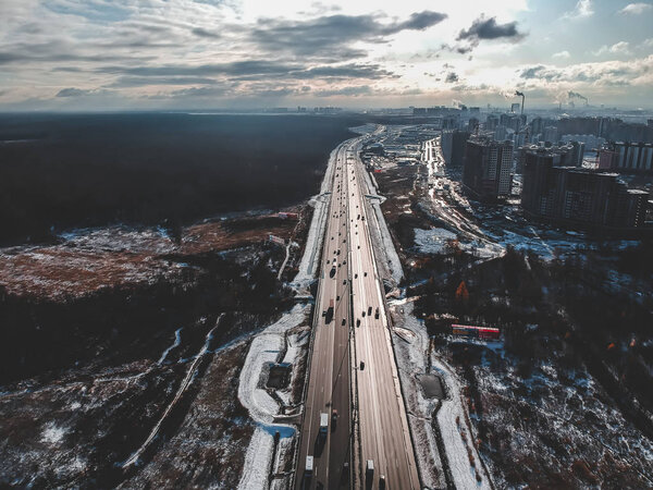 Aerial view of country road and bridge, road traffic, snow-covered forests and fields, winter. Russia, St. Petersburg. — Stock Image Aerial view of country road and bridge, road traffic, snow-covered forests and fields, winter. Russia, St. Petersburg. — Stock Photo, Image