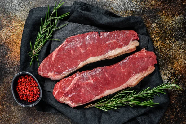 Fresh meat, marbled beef, raw sirloin steak. Dark background. Flat lay — ストック写真