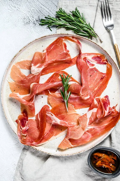 Spanish jamon Serrano, ham. Antipasto plate. Gray background, top view. — Stock Photo, Image