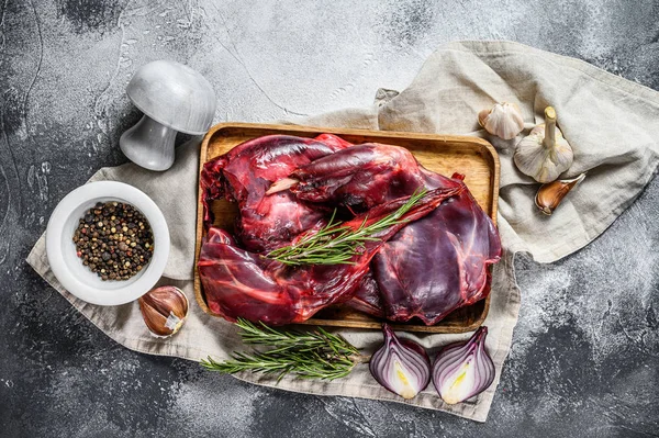 Rabbit meat. Raw fresh farm rabbit on a wooden table with vegetables and spices. Top view. Organic meat — Stock Photo, Image