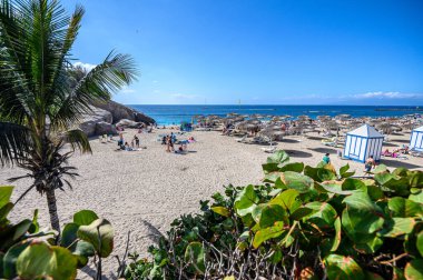Güneş yataklı, şemsiyeli ve turistli del Duque plajı. 08.01.2020 Tenerife, Kanarya Adaları