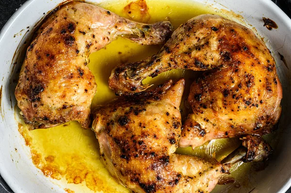 Baked chicken drumsticks with thigh, spices. Black background. Top view — Stock Photo, Image
