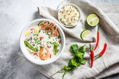 Tom Kha Gai. Tavuk ve karidesli baharatlı hindistan cevizi çorbası. Tayland yemeği. gri arka plan. Üst görünüm