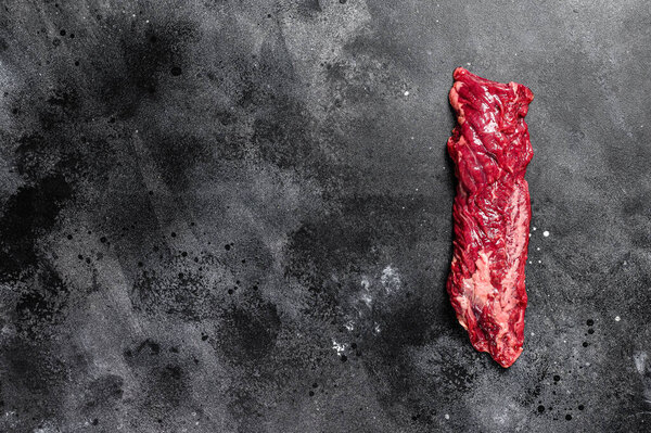 Raw skirt, machete steak. Black background. Top view. Copy space.