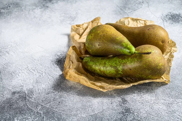 Pears on Kraft paper. Seasonal ripe pears. Gray background. Top view. Space for text.