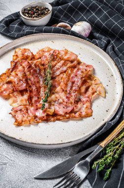 Kızarmış domuz pastırması ve kekik. Organik et. Gri arka plan. Üst görünüm.