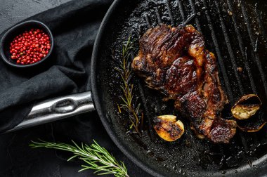 Izgara tavasında mermer biftek. Izgara et. Organik çiftlik eti. Siyah arkaplan.