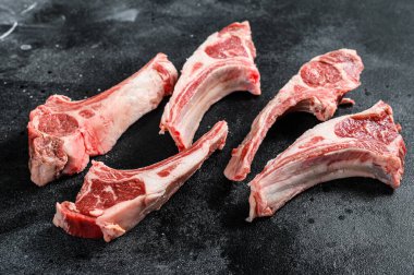 Çiğ kuzu pirzolası, kuzu pirzolası. Siyah arka plan. Üst görünüm