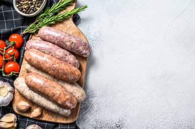 Kekik, sarımsak ve biberle çeşitli taze sosisler. Gri arka plan. Üst Manzara. Boşluğu kopyala.