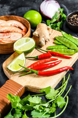 Tom Kha Gai 'yi pişirmek için gerekli malzemeler. Hindistan cevizi sütlü Tayland tavuk çorbası. Siyah arka plan. Üst görünüm.