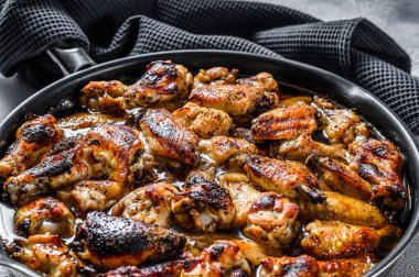 Tavada fırında pişirilmiş tavuk kanadı. Beyaz arka plan. Üst görünüm.