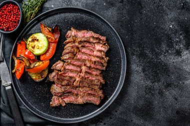 Yanında sebze tabağı olan bir tabakta Chuck 'ın göz yuvarlaması. Siyah arka plan. Üst Manzara. Boşluğu kopyala.