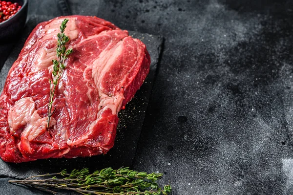 Çiğ Chuck bifteği. Organik biftek. Siyah arka plan. Üst Manzara. Boşluğu kopyala.