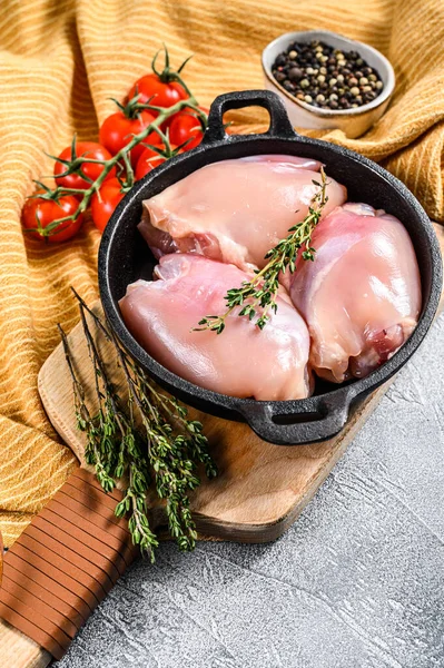 Boneless raw chicken thighs fillets. White background. Top view.