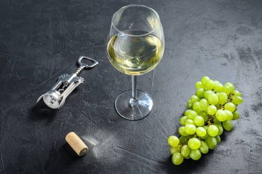 Üzüm ve mantarlı şarap kadehleri. Şarap yapma kavramı. Siyah arka plan. Üst görünüm.