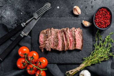 Baharatlı ve baharatlı ızgara kanatlı biftek. Siyah arka plan. Üst görünüm