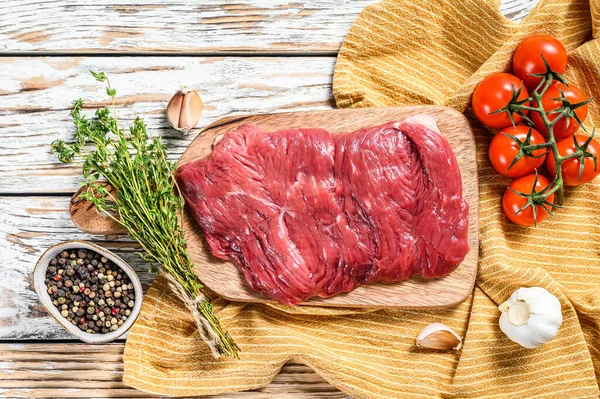 Fresh flank steak on a chopping Board. White background. Top view