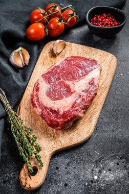 Çiğ et, pirzola ve baharatlı pirzola. Pirzola bifteği. Siyah arka plan. en üstteki görünüm.