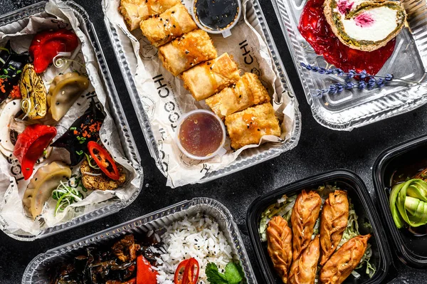 Choosing take away food. Spring rolls, dumplings, gyoza and dessert in lunch box. Take and go organic food. Thai and Asian traditional food. White background. Top view