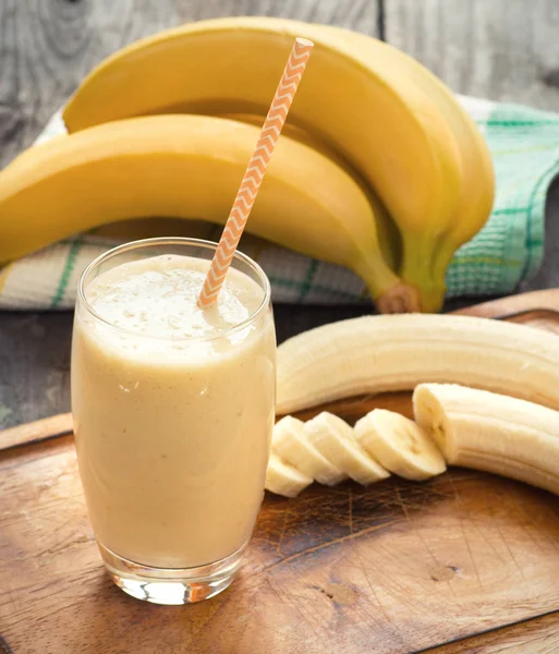 Banana smoothie on a  wooden table — Stock Photo, Image
