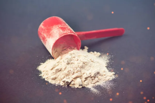 Spilled scoop of protein powder — Stock Photo, Image