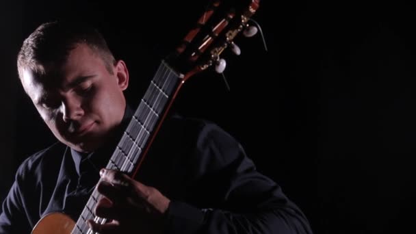 Joven Guapo Magistralmente Toca Guitarra Acústica Clásica Sobre Fondo Negro — Vídeos de Stock