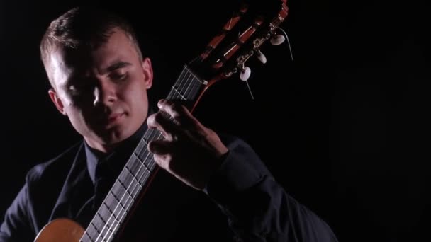 Joven Guapo Magistralmente Toca Guitarra Acústica Clásica Sobre Fondo Negro — Vídeos de Stock