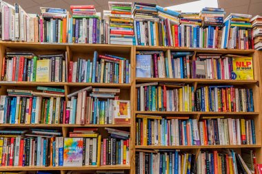 Kailua, Hawaii / Usa- 30 Aralık 2019: Kailua, Hawaii 'de kullanılmış bir kitapçıda satılık ahşap raflarda yığınla kullanılmış kitap 