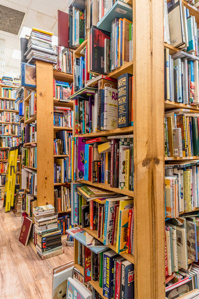 Kailua, Hawaii/USA- Dec. 30, 2019: Piles of used books on wooden shelves for sale in a used bookstore in Kailua, Hawaii 