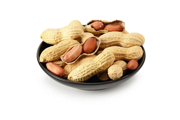 Amendoins Secos Uma Placa Preta Isolada Fundo Branco Alimentos — Fotografia de Stock