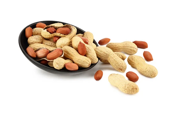 Amendoins Secos Uma Placa Preta Isolada Fundo Branco Alimentos — Fotografia de Stock