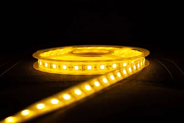 LED strip for decorative lighting,Diode led tape on dark background logo — Stock Photo, Image