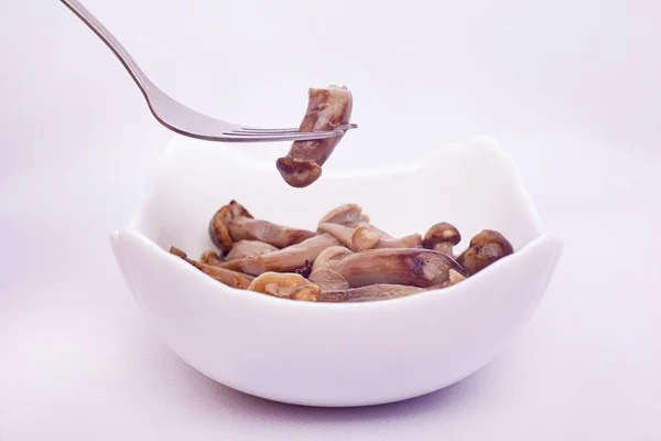 Pickled honey agaric. mushrooms honey fungus in a white plate — Stock Image Pickled honey agaric. mushrooms honey fungus in a white plate Royalty Free Stock Images