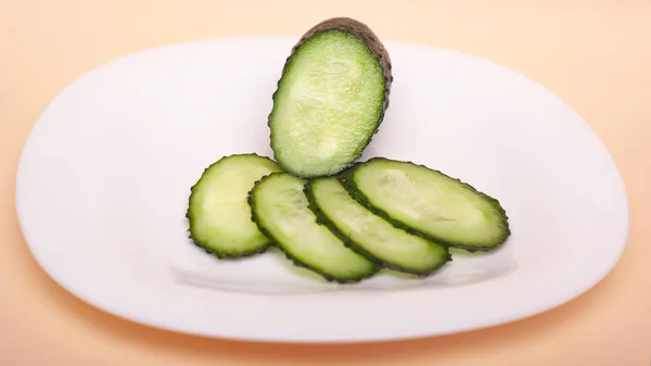 Sliced fresh cucumbers on a white plate. chopped  gherkins — Stock Photo, Image