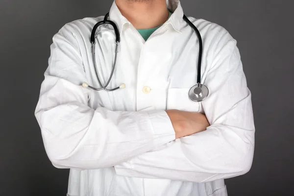 family doctor in a white coat with a stethoscope on a gray background, pediatrician, close-up