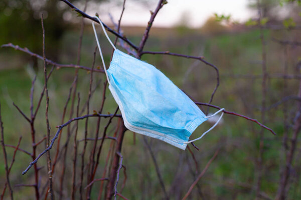 planet pollution with dirty medical masks. spring quarantine of the coronavirus pandemic covid-19