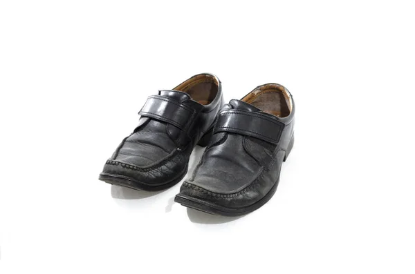 Old used and worn black leather shoes Stock Picture