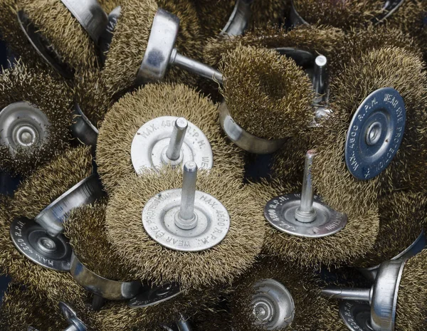 A selection of brass wire brushes for use with a drill — Stock Photo, Image