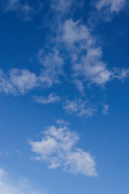 Masmavi bir gökyüzü seyrek beyaz kabarık bulutlar ile