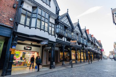 Chester, UK: Mar 1, 2020: A general street scene of Northgate Street at early evening with few shoppers. clipart