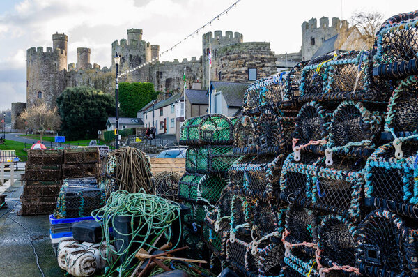 Conwy, UK : Jan 25, 2020: Lobster pots stacked neatly on the harbour of Conwy.