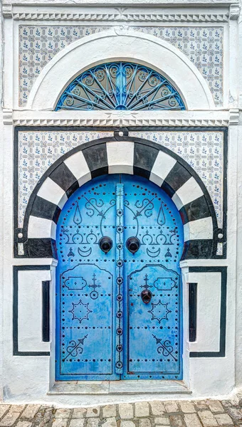 Traditional old painted door in a historical district or medina, Tunisia.