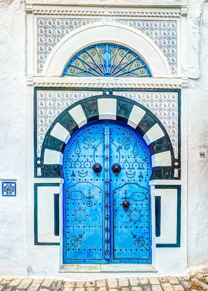 Traditional old painted door in a historical district or medina, Tunisia.