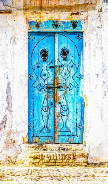 Traditional old painted door in a historical district or medina, Tunisia.