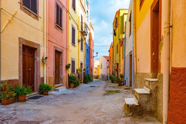 Beautiful narrow street in the picturesque Bosa old town, Italy. Colorful image of italian historic place.