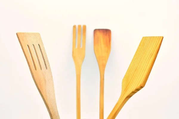 Kitchen utensils made of wood, on white background