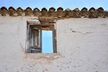 Open wooden window on a facade of an old house